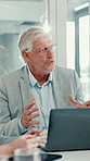 Man, talk and laptop in meeting in office for financial planning, feedback and budget review. Mature person, team and discussion for online update, investment report and information for profit growth