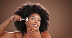 Beauty, face roller and smile with black woman in studio for cosmetics or dermatology routine. Aesthetic, facial and skincare with happy model on wall background for antiaging stone treatment