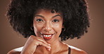 Studio, black woman and touch on face for skincare, cosmetics benefits or natural beauty with smile. Portrait, female person and model with afro for dermatology, facial glow and isolated background