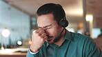 Night, businessman and burnout with headache, stress or overworked with call center deadline. Person, employee and migraine with tired, fatigue or exhausted with eye strain and typing consultant