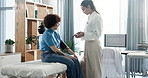 Blood pressure, consultation and doctor with patient in clinic for heart health, pulse or checkup. Sphygmomanometer, medical and physician with woman for hypertension assessment in hospital office.