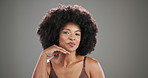 Face, beauty and black woman in studio, skincare and dermatology on grey background. African person, space and happy model with wellness, afro and aesthetic with shine, glow and makeup with cosmetics