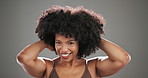 Afro, hair care and face of black woman in studio for beauty, cosmetics and curl pattern textures. Growth, salon treatment and volume with person on gray background for shine, glow and self love