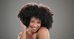 Afro, happy and face of black woman in studio for hair style, cosmetics and curl pattern textures. Growth, salon treatment and volume with person on gray background for shine, glow and beauty