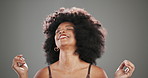Afro, shake and beauty with black woman in studio for curly hair care, texture and cosmetics. Volume, keratin and shine with person on gray background for growth, shine and natural transformation