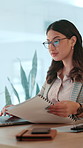 Woman, laptop and documents at startup, typing and admin with project management at media company. Person, writer and editor with computer, paperwork and review for article with research at agency