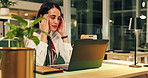 Tired woman, headache and night with stress on laptop for overtime or project deadline at office. Female person, employee or working late with migraine on computer desk for pressure at workplace