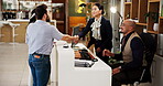 Hotel, people and receptionist with handshake for welcome, introduction and help for accommodation. Men, women and concierge with shaking hands for greeting, hospitality service or check in for guest