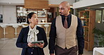 Hotel, tablet or walking with concierge and manager in lobby for booking, reception or reservation. Collaboration, hospitality and schedule with resort staff in lounge for planning or service