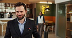 Hotel, man and client in lobby, hospitality and walking with smile, luxury resort and confidence. Travel agency, people and customer in hallway, happiness and reception with guest and reservation