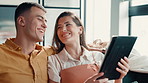 Couple, laughing and scroll with tablet on sofa for social media meme, funny post or comedy video. People, bonding together and pointing to digital app in home for web browsing and streaming service