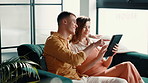 Couple, laughing or pointing to tablet in home for online shopping, app choice or purchase decision. Relax, people and bonding together with digital tech on sofa for reading information and research