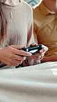 Hands, video game and couple in home playing for entertainment, virtual contest and challenge. Living room, dating and man with woman with controller for digital competition, bonding and weekend fun