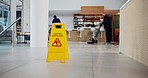 Janitor, group and office with caution sign, hygiene service and wet floor for disinfection. Attention, safety and warning for risk, teamwork and cleaner for maintenance, tile polishing and equipment