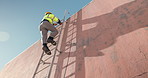 Man, technician and climbing wall on ladder with helmet for rooftop installation or construction, Low angle, back view or cable contractor moving up steps for electrical checkup or service on space