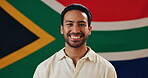 Face, man and confidence with flag for South Africa, smile and pride with happiness for citizen. Portrait, male person or patriotic with fabric for nationality, country or positive attitude by symbol