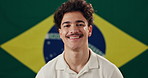 Man, face and happy with Brazil flag in studio for national pride, confidence and patriot by background. Person, model and smile in portrait with symbol, respect and sign with loyalty to country