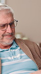 Retirement, online and senior man with tablet, smile or glasses for reading, break and social media. Happy, elderly person and entertainment with tech in home, relax and pensioner on website with app