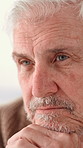 Home, thinking and old man with doubt, sad and mental health with reflection. Pensioner, apartment and elderly person with history, depression and alzheimer with memory, nostalgia and retirement