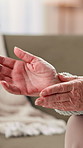 Hands, senior woman and wrist pain in home with arthritis, inflammation and carpal tunnel syndrome. Pensioner, elderly person and massage joint with osteoporosis, fibromyalgia risk and muscle tension
