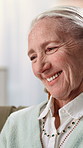 Senior woman, smile and memory on sofa in home for reflection, thinking or nostalgia in retirement. Elderly person, happy and remember on couch, relax and perspective in living room at apartment