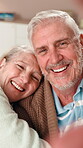 Face, selfie and smile of senior couple in living room of retirement home together for affection. Bonding, hug or security with elderly man and woman in apartment for love, memories or photograph