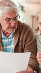 Senior couple, reading and document at house for financial plan, payment statement and savings. Elderly people, paperwork and mortgage expenses, pension balance and finance invoice of retirement fund