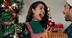 Christmas tree, excited and couple in home with decoration for holiday, vacation or festive season. Happy, love and people with baubles, ornaments and ball for xmas tradition, bonding and celebration