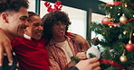Christmas, tree and help with friends at party for festive season, celebration and decoration. Happiness, bonding and xmas holiday with people in living room of home for tinsel, ornament and support