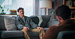 Mental health, talking and man on sofa with therapist for consulting, counseling and therapy session. Psychology, communication and psychologist with patient for emotional support, advice and help