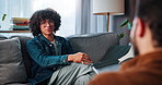 Psychology, sofa and man with healing in counseling, anxiety management and talking with therapist. Therapy, male patient and psychologist with notebook for assessment, listening and share recovery