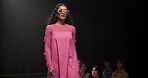 Fashion, show and runway with woman at event for designer collection, clothing showcase and couture. Fabric, wardrobe and luxury catwalk with model walking on stage for trendy, and style industry