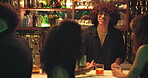 Smile, bartender and friends with alcohol at club for customer,  server and happy hour at counter. Man, mixologist and people with cocktail beverage at bar or pub for cheers, social event and party
