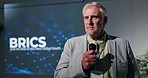 Education, presentation and speech with business man on stage in auditorium for BRICS seminar. Conference, development and update with mature speaker on podium for lecture on emerging economies