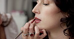 Makeup artist, backstage and lipstick with women in studio for cosmetics, fashion and makeover. Stylist, beautician and behind the scenes with people for lip routine, model touch up and talent