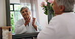 Mature, happy woman and spa with mirror for face cream or moisturizer at beauty salon. Senior, female person or smile with reflection, lotion or robe for skincare or facial treatment at luxury resort