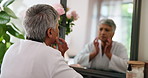 Mirror, mature woman and sad with skincare, anti aging and cosmetics results. Pensioner, depression and elderly lady with reflection, grooming or treatment fail for wrinkles or dermatology in house