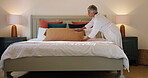 Bedroom, woman and making bed in home, chores or routine for maintenance of mattress, tidy or clean. Neat, morning and organizing pillows, housework and mature person with blanket in apartment