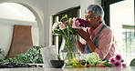Mature woman, flowers and smell with vase for natural growth, gift or present at home. Old, female person or smile with floral aroma or scent for nature fragrance, house decor or plant in water
