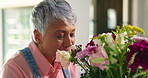Flowers, getting ready and scent with woman in BNB for accommodation, hospitality or small business. Aroma, bouquet and setup with mature guest house owner in dining room for floral arrangement