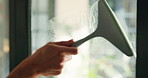 Cleaning, window and hands of person with wiper for hygiene, housekeeping and maid service. Washing, glass and cleaner with spray bottle, detergents and liquid for bacteria, disinfection and dust
