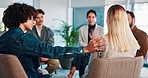 Counseling, empathy and group therapy with people in office together for advice, healing or understanding. Meeting, support and workshop with woman speaking to therapist in session for psychology