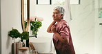 Cosmetics, mature woman and haircare in mirror for hydration treatment, natural beauty and results. Reflection, person and happy with morning routine inspection for grooming and check hair in home