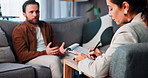 Woman, therapist and clipboard with talk, patient and questions for evaluation on sofa at clinic. Person, psychology and writing for anxiety, depression and assessment for consultation on couch