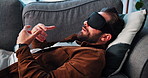 Man, talking or eye mask for psychology therapy, hypnotherapy or hypnosis on sofa at home. Male person, relax and speaking with therapist or rest for trauma, PTSD counseling or psychotherapy at house