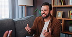 Happy man, therapist and counseling with client on sofa for discussion, advice or chat at home. Male person, psychologist or counsellor talking with explanation for mental health or therapy session