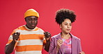 Party, energy and couple in studio dancing for bonding or fashion on red background. Rhythm, sound or creative people listening to fun music to celebrate with relationship, support and cool outfits
