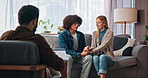 Happy, couple and talking to therapist, sofa or holding hands for pre marital session or counseling. Consultation, man and woman with psychologist for communication skills, smile and people on couch
