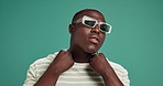 Black man, fashion or sunglasses with confidence for swag or style on a green studio background. Portrait, male person or serious African model with pop collar, shades or eyewear on mockup space