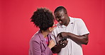 Couple, phone and laugh in studio with funny video, meme or comic post on social media by background. African people, man and woman with smartphone, happy and share with mobile app for streaming